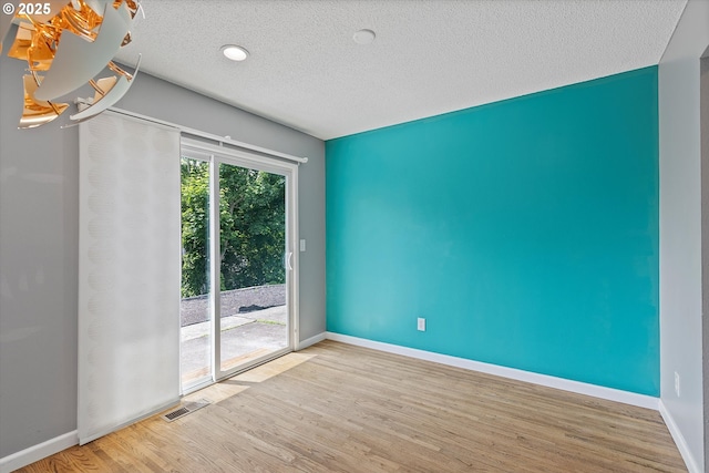 721 NW 76th St, Vancouver, WA 98665 - unfurnished room featuring wood finished floors, baseboards, and a textured ceiling