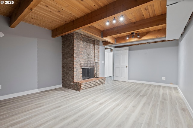 721 NW 76th St, Vancouver, WA 98665 - unfurnished living room with wooden ceiling with exposed beams, wood finished floors, baseboards, and a brick fireplace