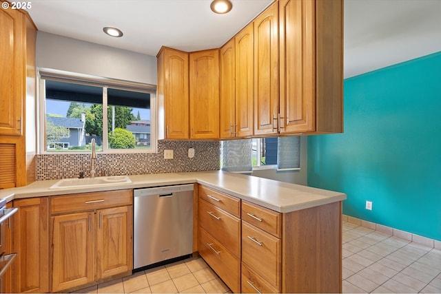 721 NW 76th St, Vancouver, WA 98665 - kitchen featuring stainless steel dishwasher, a sink, a peninsula, tasteful backsplash, and light tile patterned flooring