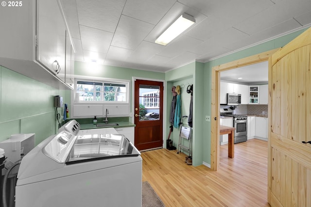35478 Brabham Rd, Pleasant Hill, OR 97455 - laundry area featuring washer and clothes dryer, cabinet space, light wood-style flooring, and crown molding
