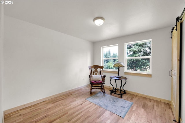 35478 Brabham Rd, Pleasant Hill, OR 97455 - living area featuring a barn door, light wood-type flooring, and baseboards