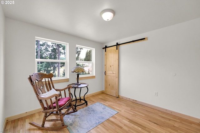 35478 Brabham Rd, Pleasant Hill, OR 97455 - living area featuring a barn door, light wood finished floors, and baseboards