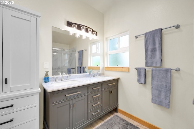35478 Brabham Rd, Pleasant Hill, OR 97455 - bathroom featuring a stall shower, double vanity, wood finished floors, and baseboards