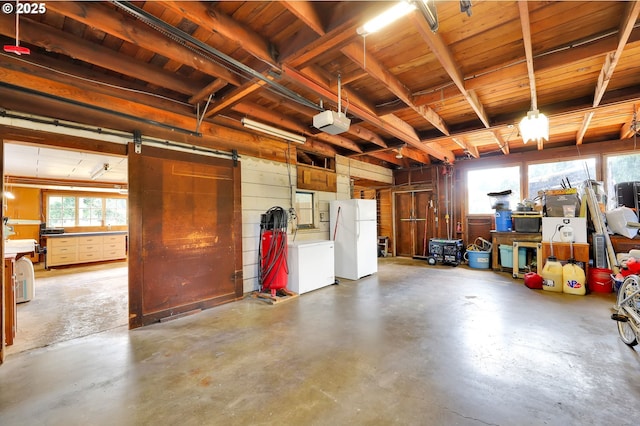 35478 Brabham Rd, Pleasant Hill, OR 97455 - garage with freestanding refrigerator, a garage door opener, refrigerator, wood walls, and wood ceiling