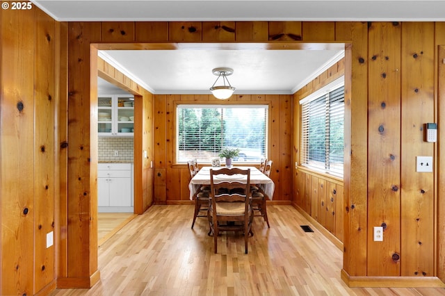 35478 Brabham Rd, Pleasant Hill, OR 97455 - dining area featuring healthy amount of natural light, light wood finished floors, crown molding, baseboards, and wood walls