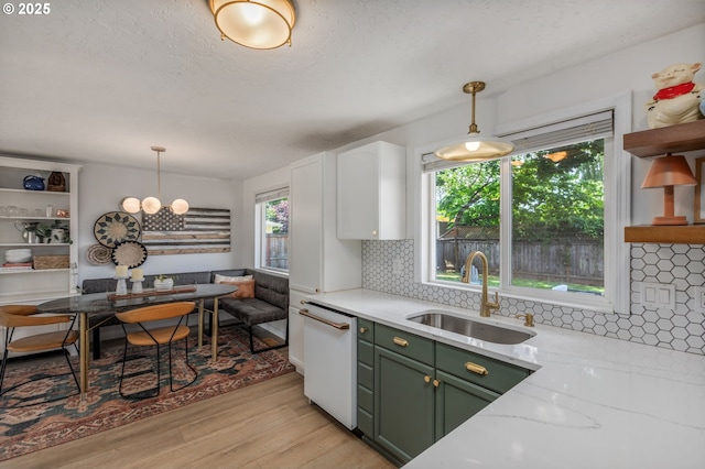 1001 S Grant St, Canby, OR 97013 - kitchen with green cabinetry, white dishwasher, light wood-type flooring, open shelves, and tasteful backsplash