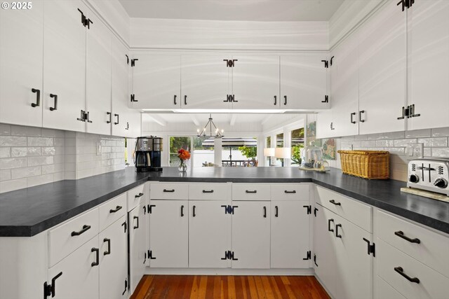 1667 Lake Front Rd, Lake Oswego, OR 97034 - kitchen featuring dark countertops, wood finished floors, tasteful backsplash, and white cabinets