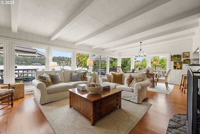1667 Lake Front Rd, Lake Oswego, OR 97034 - living room featuring beam ceiling, light wood-style flooring, and a chandelier