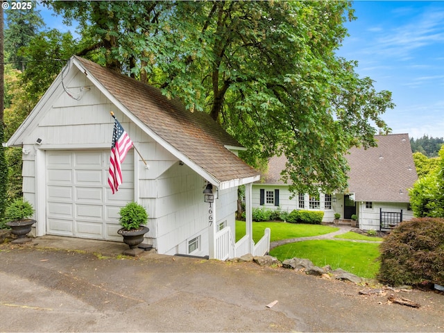 1667 Lake Front Rd, Lake Oswego, OR 97034 - view of front of property featuring roof with shingles, a front lawn, a garage, and an outbuilding