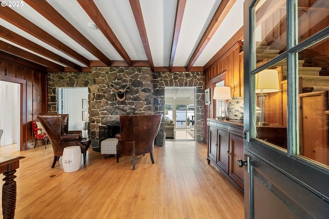 1667 Lake Front Rd, Lake Oswego, OR 97034 - living area featuring beamed ceiling, light wood-style flooring, wood walls, and a stone fireplace