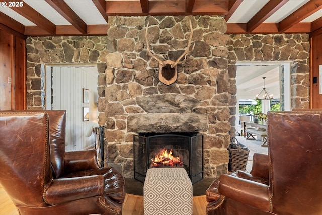 1667 Lake Front Rd, Lake Oswego, OR 97034 - sitting room with beam ceiling, a stone fireplace, wood finished floors, and a chandelier