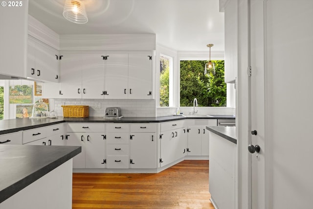 1667 Lake Front Rd, Lake Oswego, OR 97034 - kitchen with dark countertops, tasteful backsplash, and white cabinets