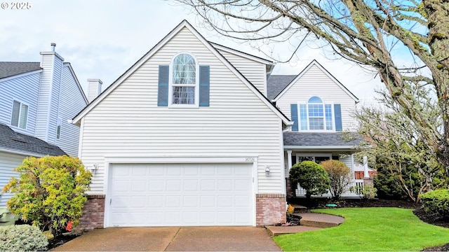 traditional-style home featuring a garage, brick siding, driveway, and a front lawn