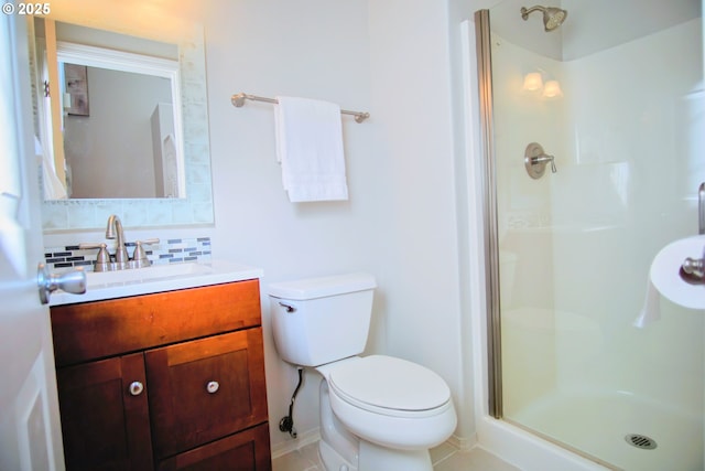 full bathroom featuring toilet, a shower stall, decorative backsplash, and vanity