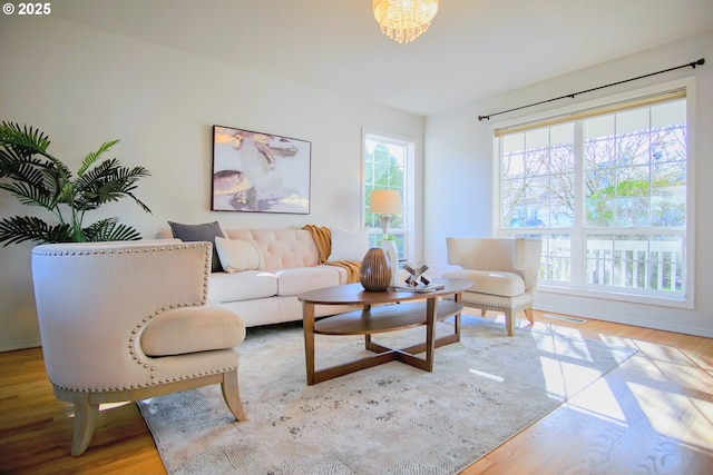 living room with a chandelier and wood finished floors