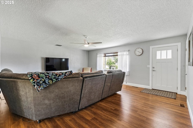 1050 D St, Baker City, OR 97814 - living room with dark wood-type flooring, a ceiling fan, and a textured ceiling