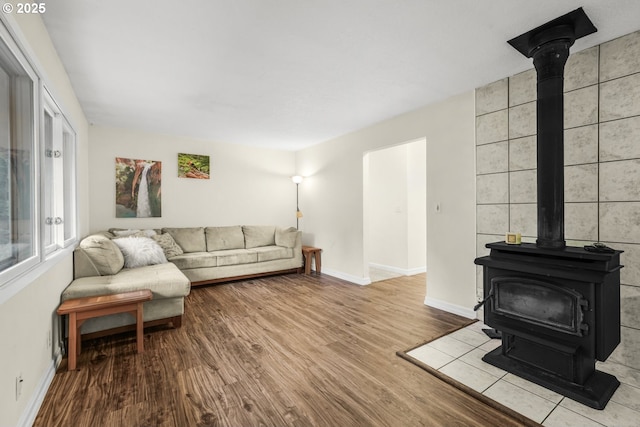 19330 NW Curtis Creek Dr, Manning, OR 97125 - living room featuring a wood stove, wood finished floors, and baseboards