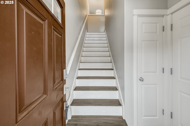 stairs featuring wood finished floors