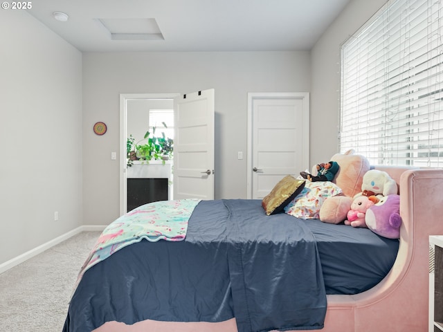 bedroom with multiple windows and light carpet