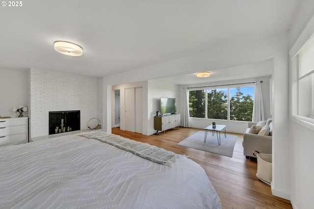 2435 Skyline Blvd, Eugene, OR 97403 - bedroom with wood finished floors and a fireplace