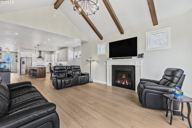 32750 Macy St, Eugene, OR 97408 - living area with a chandelier, beamed ceiling, light wood-style floors, recessed lighting, and a glass covered fireplace