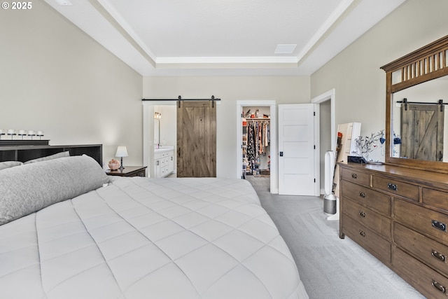32750 Macy St, Eugene, OR 97408 - carpeted bedroom with a barn door, a walk in closet, a closet, a raised ceiling, and ensuite bathroom