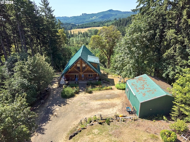 drone / aerial view with a mountain view and a view of trees
