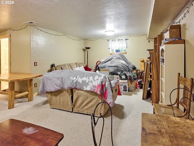 bedroom with a textured ceiling, visible vents, a textured wall, and carpet