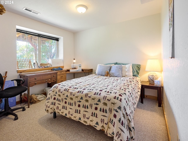 bedroom with visible vents and carpet