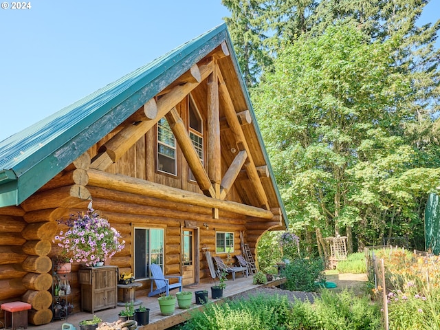 back of house featuring log siding