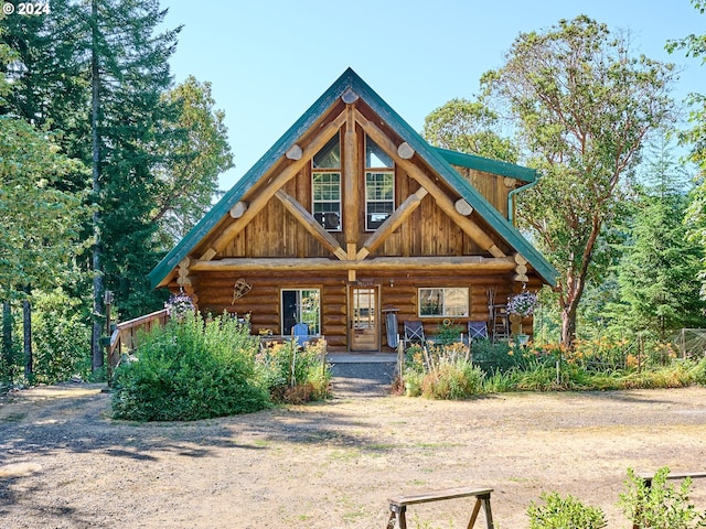 log home featuring log siding, board and batten siding, and a porch