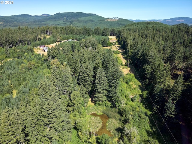 drone / aerial view with a mountain view and a forest view