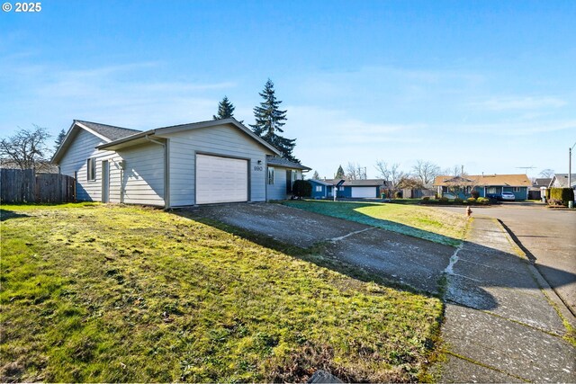 single story home with a front yard and a garage