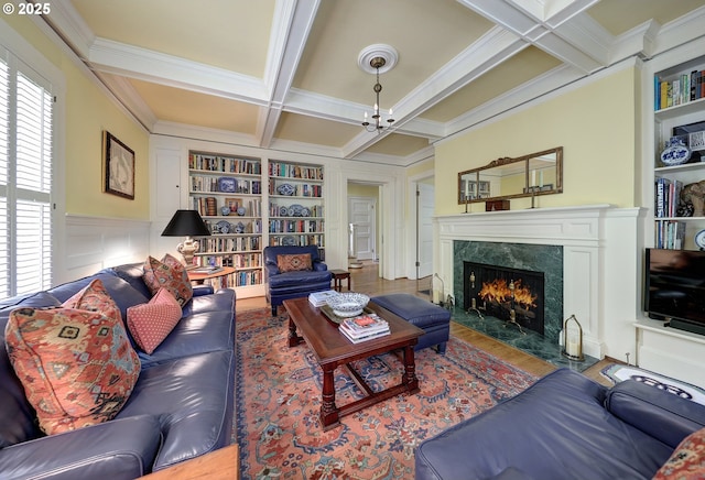 living room with coffered ceiling, beamed ceiling, built in features, and a fireplace