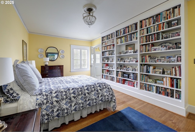 bedroom featuring hardwood / wood-style flooring and crown molding