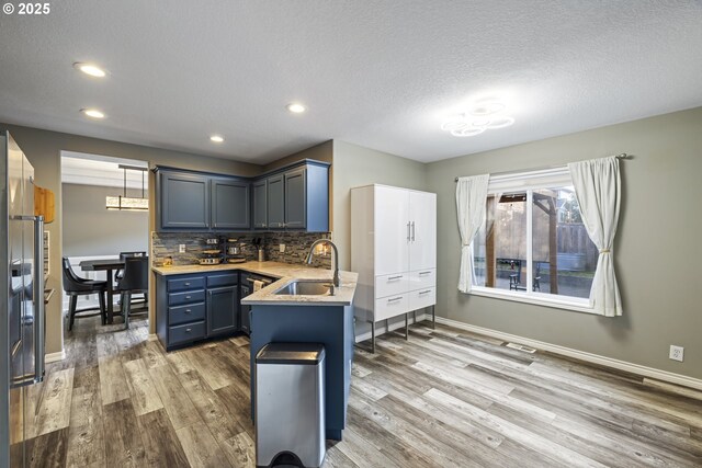 22647 SW Saunders Dr, Sherwood, OR 97140 - kitchen with stainless steel appliances, a sink, backsplash, recessed lighting, and blue cabinets