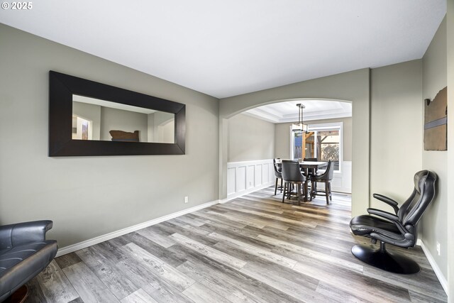 22647 SW Saunders Dr, Sherwood, OR 97140 - sitting room featuring wood finished floors, arched walkways, and a chandelier