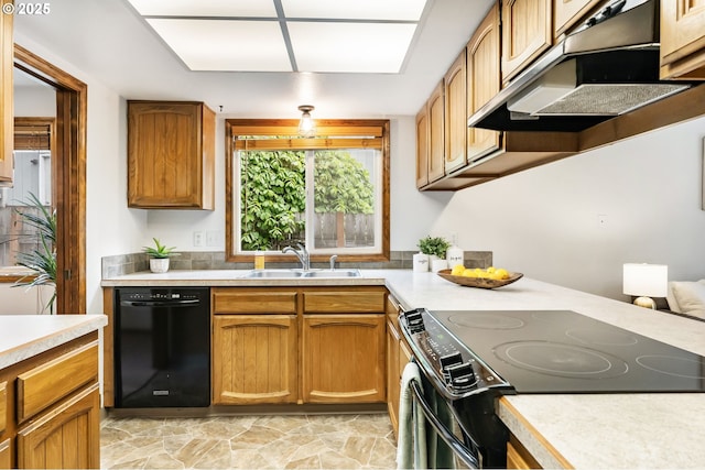 kitchen with under cabinet range hood, a sink, black appliances, and light countertops