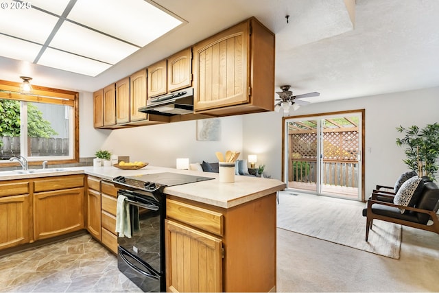 kitchen featuring electric range, ceiling fan, a sink, light countertops, and under cabinet range hood
