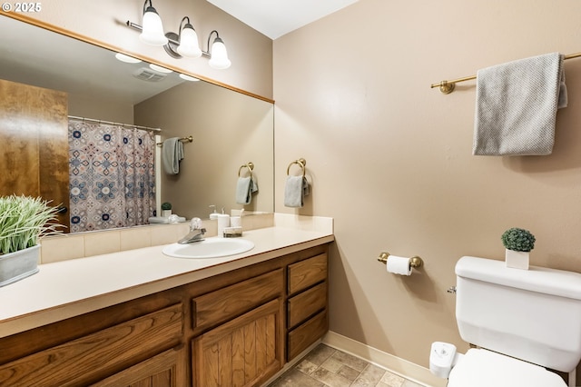 bathroom featuring visible vents, vanity, toilet, baseboards, and a shower with shower curtain