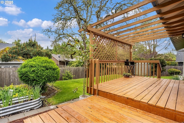 wooden deck featuring a lawn, a fenced backyard, and a pergola