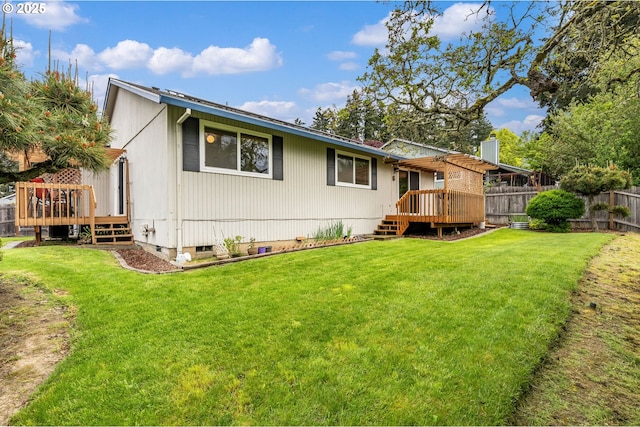 rear view of property featuring crawl space, fence, a yard, and a deck