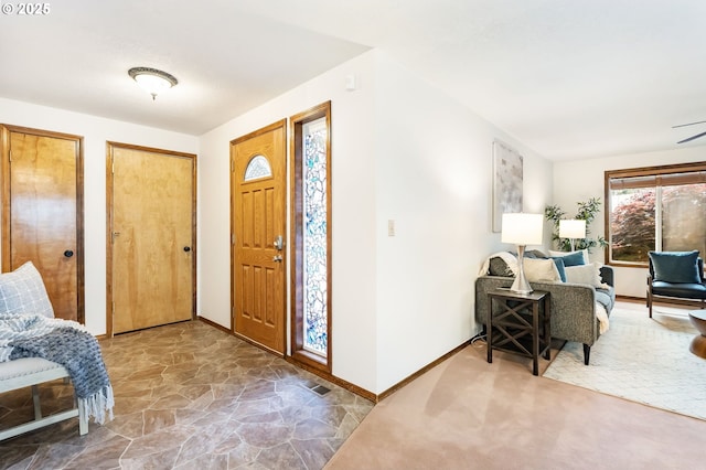entrance foyer with baseboards and stone finish flooring
