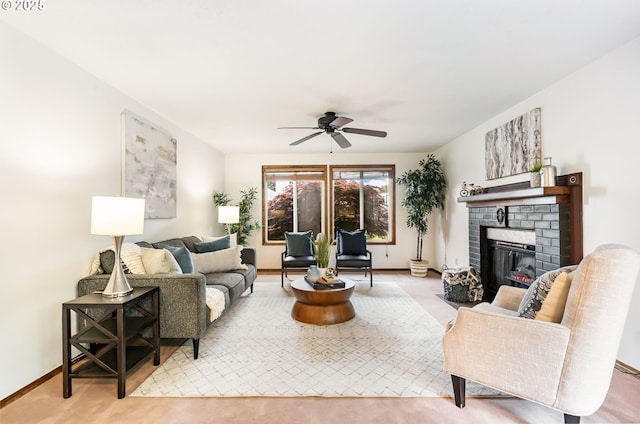 living area featuring baseboards, a ceiling fan, and a brick fireplace
