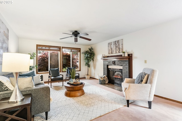 living area with light colored carpet, baseboards, a brick fireplace, and ceiling fan