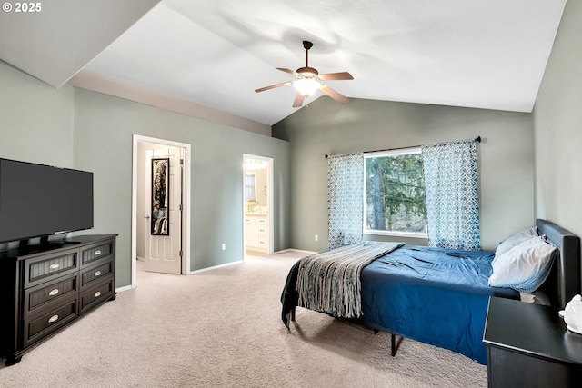 carpeted bedroom featuring ceiling fan, ensuite bathroom, and vaulted ceiling