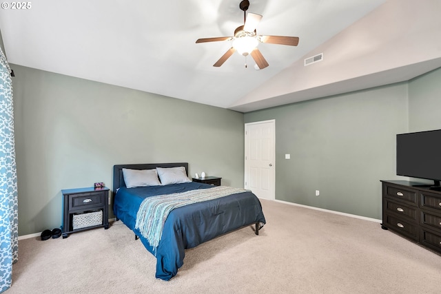 bedroom featuring ceiling fan, vaulted ceiling, and light carpet