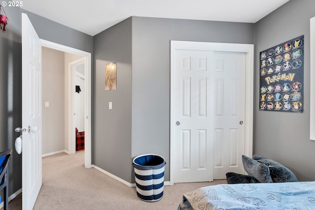 bedroom featuring light carpet and a closet