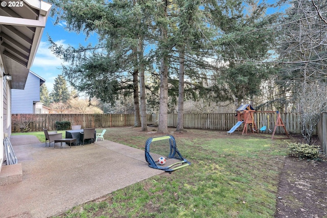 view of yard featuring a playground and a patio area