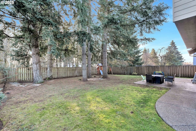 view of yard featuring a playground and a patio area